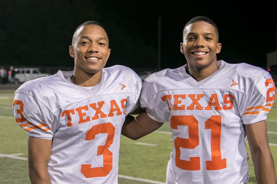 Senior Eric Sutton (left) and sophomore Chris Sutton (right) pose for a photo together. The brothers play together on the varsity football team this year.