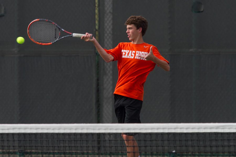 Freshman Walker Trippe returns a ball to his opponent. 