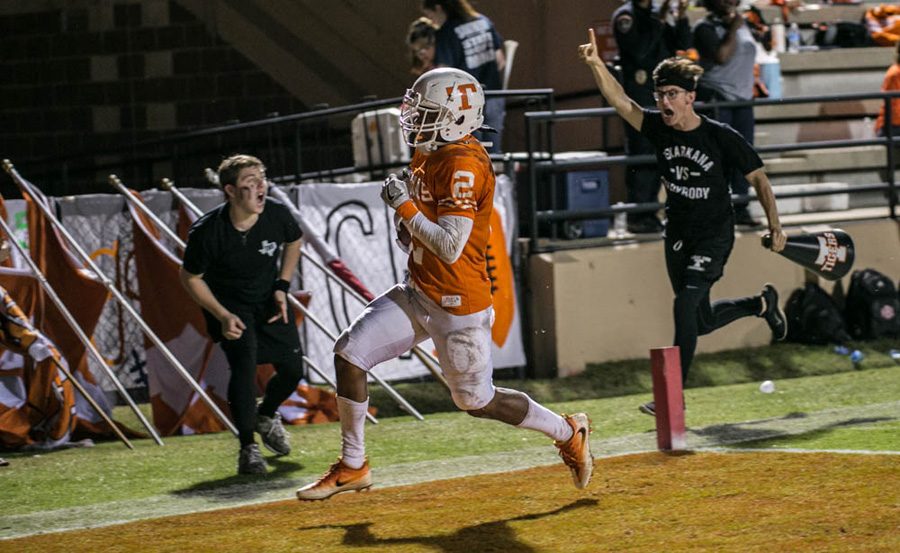 Cheer escorts Slyder Welch (left) and Tye Shelton (right) celebrate a touchdown by Texas Highs Quan Hampton. Hampton broke a single season reception record with 66 catches for the 2016 season.