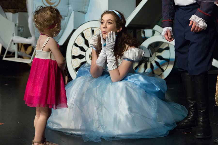 Senior Grace Hickey, who plays Cinderella, talks animatedly to one of the young attendants of Tea with Cinderella. The event was held on Jan. 21, a few hours before the second showing of the play.