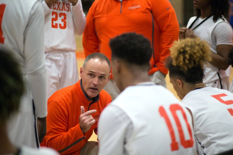 Head coach Keith Jones talks to the team on the sidelines at their game against Sulfur Springs. The Tigers ended their season with 17 wins and 10 losses.