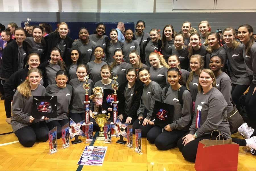 The Texas HighSteppers pose next to their numerous awards. Drill team competed in the American Dance/Drill Team Gussie Nell Davis Classic on Feb. 18. Submitted photo