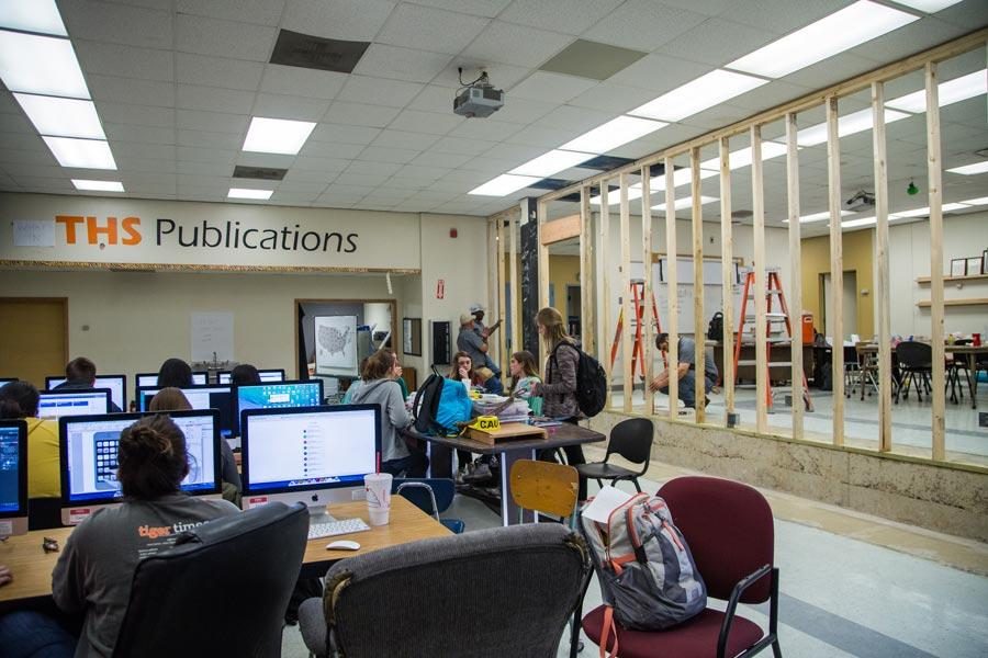 Construction workers assemble the frame of the wall during class. The publications room was divided in half so the photography class could be nearby.