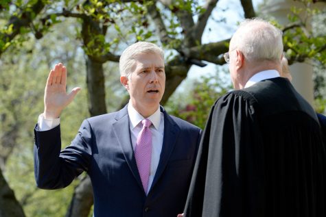 Justice Anthony Kennedy swears in Neil Gorsuch as an Associate Justice of the Supreme Court during a ceremony at the White House Rose Garden April 10, 2017 in Washington, D.C. 