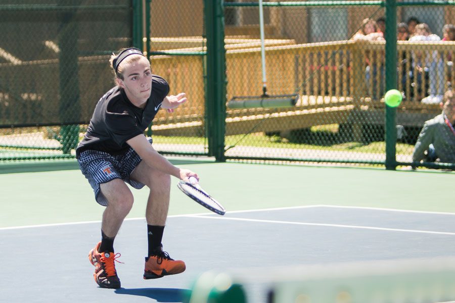 Sophomore Grant Rommel lunges for the ball during the last match of the district tennis tournament. The tournament took place on April 5-6 at Texas High.