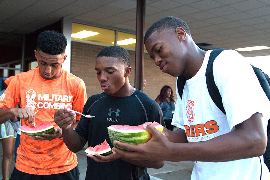 Senior+Elias+Thurman+and+juniors+Chris+Sutton+and+Kendall+Reed+enjoy+the+Watermelon+Supper.