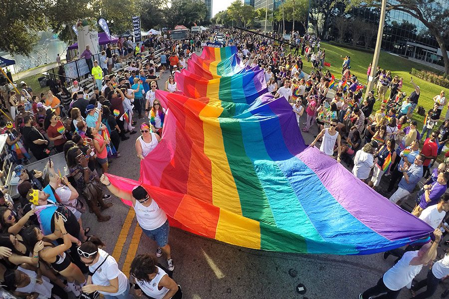 Participants in the Come Out With Pride Orlando Parade carry a massive pride flag up East Robinson Street, in downtown Orlando, Fla., on Saturday, Nov. 12, 2016. The parade is the highlight of one of the largest Pride festivals in the state. (Joe Burbank/Orlando Sentinel/TNS)