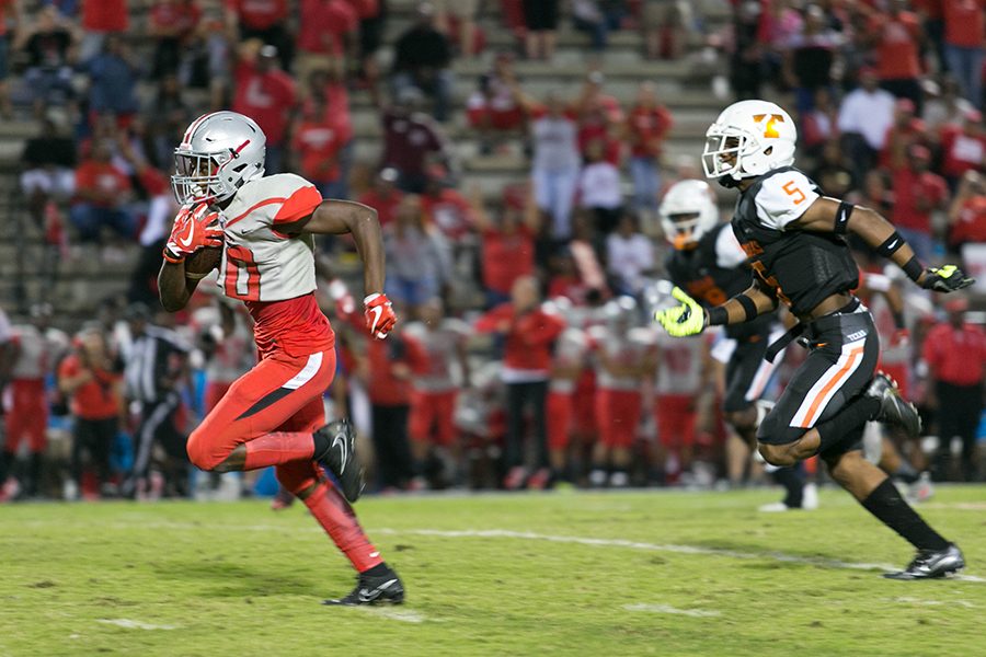 Marshall High Schools SeLah Smith breaks through the Texas High defense Friday night in the Mavericks 35-33 victory over the Tigers. The loss made the Tigers record 2-3.