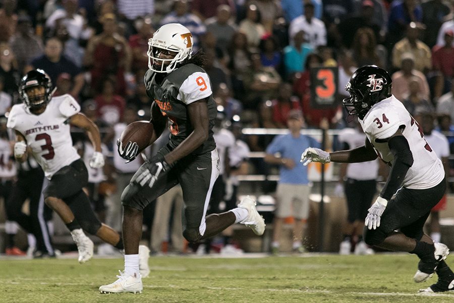 Texas Highs Tevailance Hunt splits the seam between Liberty-Eylau defenders. The Tigers snap a 3 game losing streak with a 37-23 victory over the Leopards.