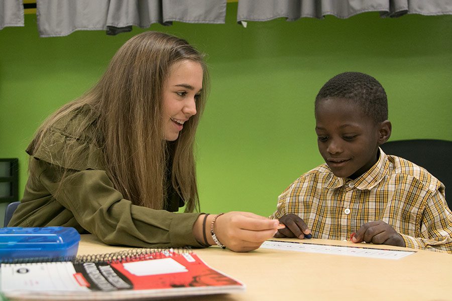 Senior Anna Morgan teaches a student math at Theron Jones Elementary as part of her mentorship program through the Leadership class. High school students have been mentoring elementary students all semester and will continue through the rest of the year.