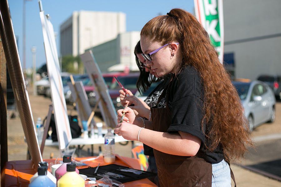 Sophomore Anolyn Keenum, a member of Art Club, paints downtown at the Second Saturday Trade Day. Local artists were featured at the event in order to bring attention to the downtown area.