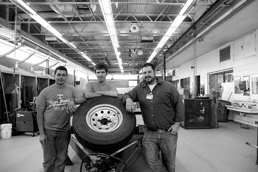 Sophomores Blake Bergagnini and Abraham Vasquez and teacher Robert Pessle stand by their project which won an award at the Four States Fair recently. Metal Design and Wood Shop projects placed third and first in competition.