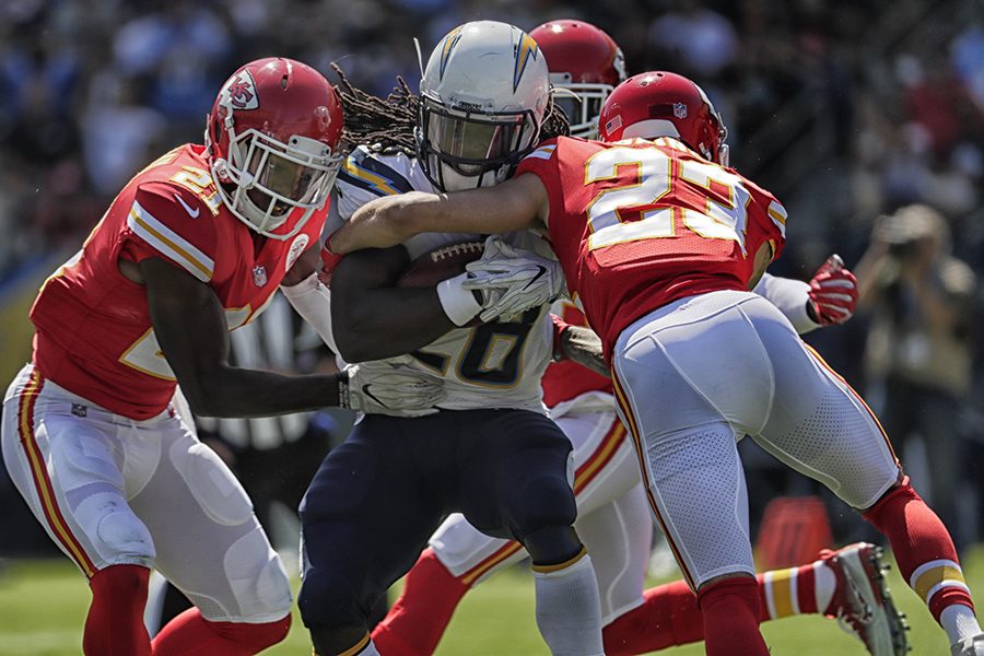 Los Angeles Chargers running back Melvin Gordon is wrestled to the ground by Kansas City Chiefs defenders during a first-half run at StubHub Center in Carson, Calif., on Sunday, Sept. 24, 2017. The Chiefs won, 24-10. (Robert Gauthier/Los Angeles Times/TNS)