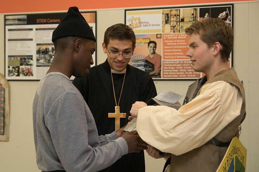 Seniors Mason Higginbotham, CJ Swift, and Kenan Parker admire each others costumes during the annual Feast and Follies celebration.