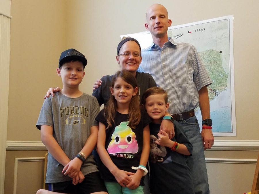 Algebra II teacher Nicole Ayers stands with her husband, Brandon, and children, Christopher, 11, Katherine, 9, and Daniel, 8. During the summer, the family competed in Brain Chase, an academic treasure hunt. The family won the competition, which included a $10,000 prize. submitted photo