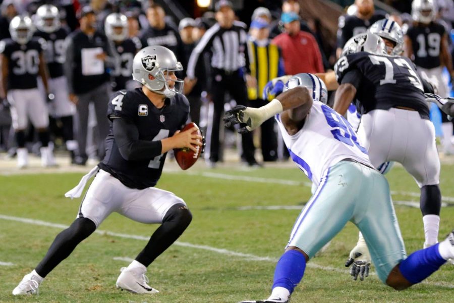 Oakland Raiders quarterback Derek Carr (4) passes under pressure from Dallas Cowboys defensive end Demarcus Lawrence (90) on Sunday, Dec. 17, 2017 at Oakland-Alameda County Coliseum in Oakland, Calif. (Rodger Mallison/Fort Worth Star-Telegram/TNS)