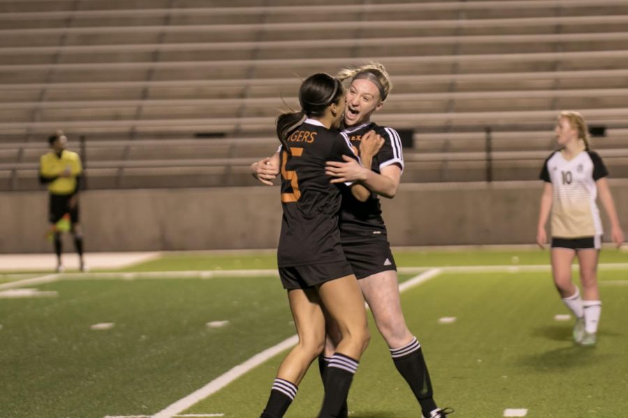 Junior Kendyl Myers and senior Chloe Coake embrace after the Tigers score their first goal.