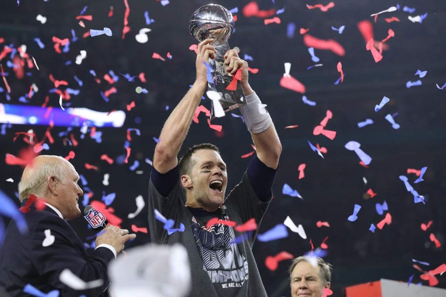 Tom Brady hoists the Lombardi Trophy, winning his fifth Super Bowl title, as the New England Patriots beat the Atlanta Falcons 34-28 in Super Bowl LI on Sunday, Feb. 5, 2017 at NRG Stadium in Houston, Texas. (Curtis Compton/Atlanta Journal-Constitution/TNS)