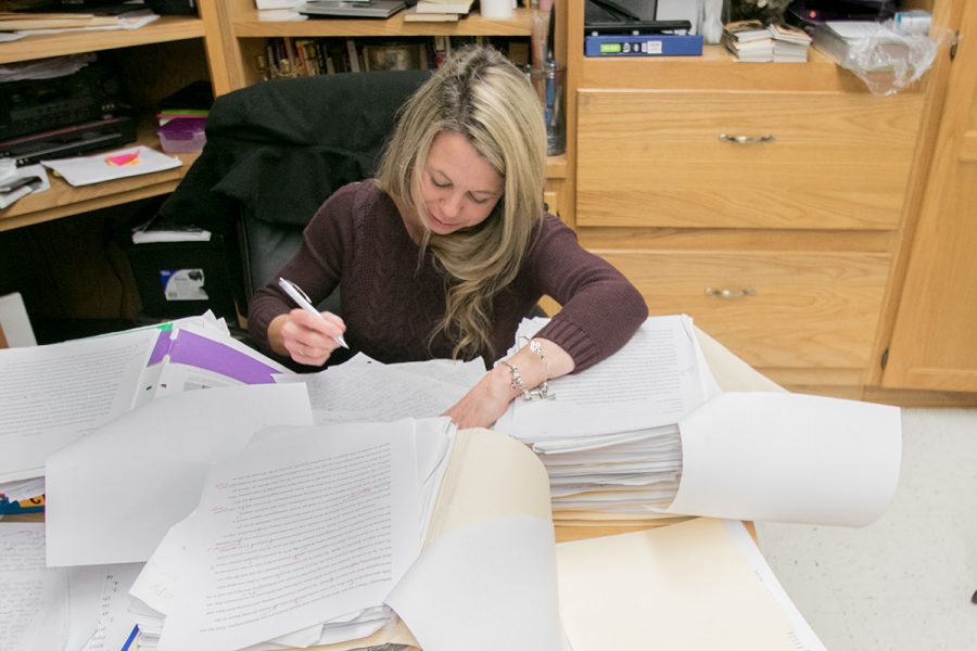 English teacher Michele Rigdon works on grading papers. She teaches multiple English classes and is dedicated to the success of her students.