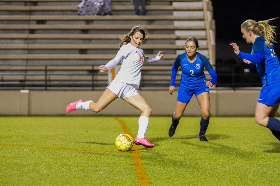 In attempt to score a goal, Junior Sarah Rodgers takes a shot at her opponents goal. 