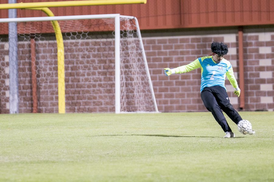 Sophomore Alfonso Vargas strikes the ball across the field from the goal box. The Tigers play in Mount Pleasant on Friday, March 9.