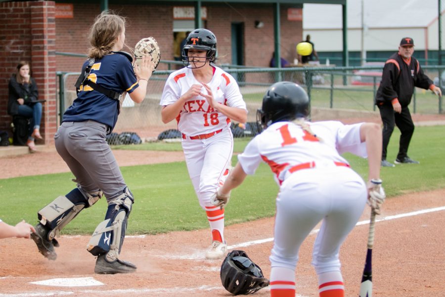 Sophomore Alexis Bolden prepares to collide with the catcher as senior Ryan Williams yells for her to slide into home plate. Bolden would score a 4-2 victory over Pine Tree.