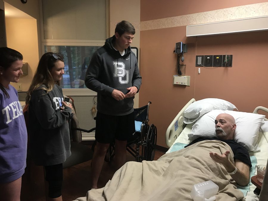 Government teacher John P. Littman talks to seniors Addison Rogers, Sarah Stark and Logan Snell at the hospital. Littman experienced a stroke a month ago, and later received the news that he now has stage four cancer. Submitted photo