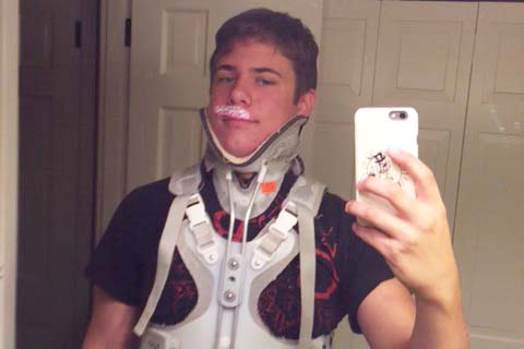 Junior Briley Court photographs himself with his hospital brace. He was hospitalized after an impactful car accident.