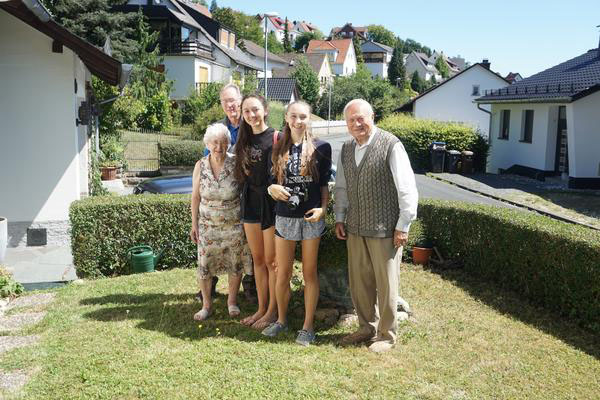 Charli Hüter and her family pose in front of her grandparents home in Hessen, Germany. Charli visited her family this past summer.