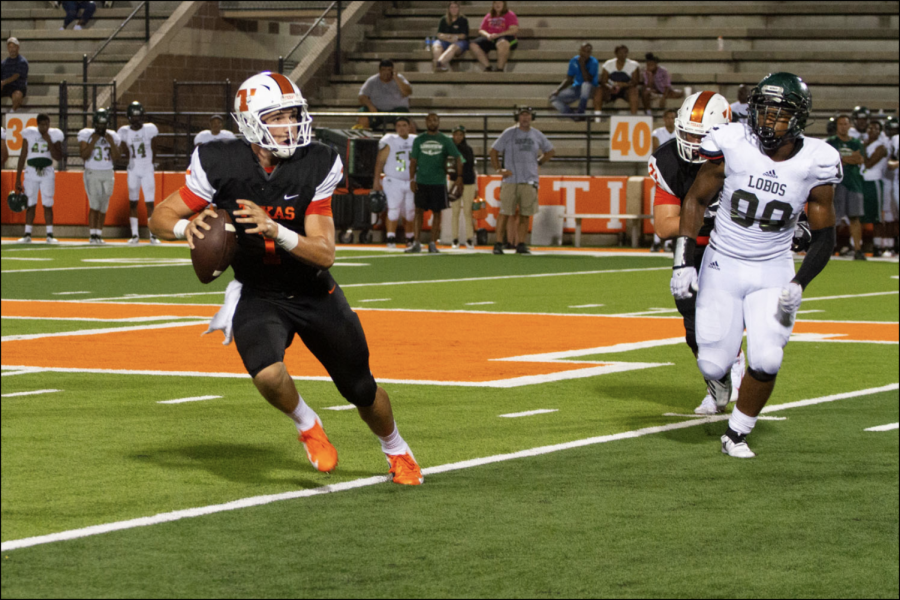 Senior quarterback Coltin Clack scrambles after being rushed by the Longview defense. The Tigers faced off against the Lobos at Tiger Stadium on Friday night.