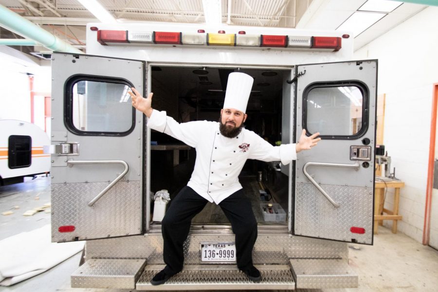 Culinary arts instructor Cory House stands in the back of the old TigerVision ambulance showing his excitement about the opportunity to turn the ambulance into a food truck. TigerVision received a new ambulance, and the culinary department hopes    to raise $10,000 to convert it to a food truck.  