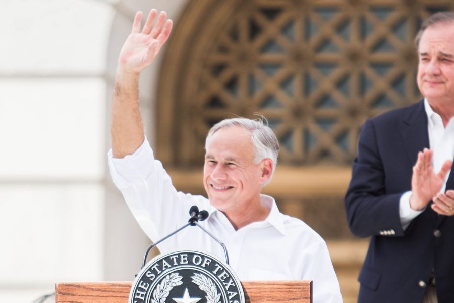 Governor Greg Abbott of Texas waves at the crowd in front of the courthouse at the announcement of REDI, or the Regional;l Economic Development Initiative. Abbott joined the Governor of Arkansas Asa Hutchinson and several representatives and senators from both states including Texarkana Mayors Bob Bruggeman and Ruth Penney Bell to make the historic announcement.