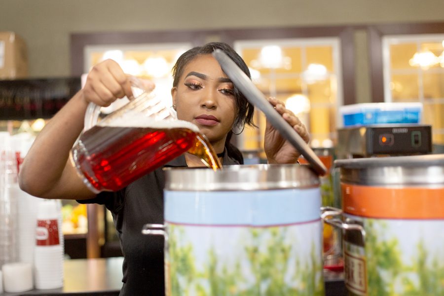 While working at Golden Corral, senior Miracle Watson refills the sweet tea container. 