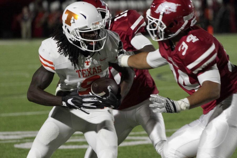 Former wide receiver Tevailance Hunt is met by Arkansas High defenders after catching a pass. The Tigers lost last season’s matchup by a score of 7-0.