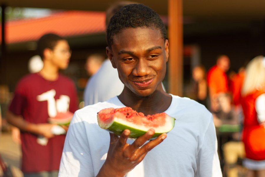 Students converse over watermelon at the annual back-to-school Watermelon Supper which was held in the Texas High courtyard to celebrate  the start of school.
