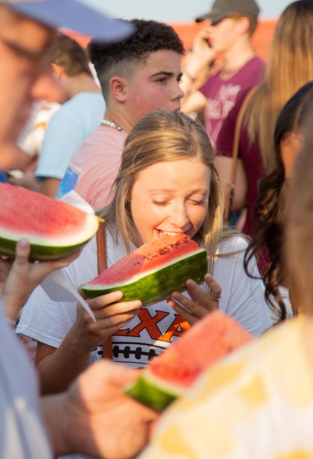 Senior Sydney Stewart enjoys a slice of watermelon at the annual Watermelon supper. Students of Texas High gathered to celebrate the beginning of the school year.