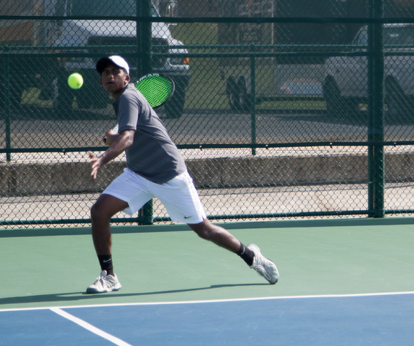 Junior Jebin Justin prepares to return a shot against Evangel. The tennis team won this match and has found early season success.