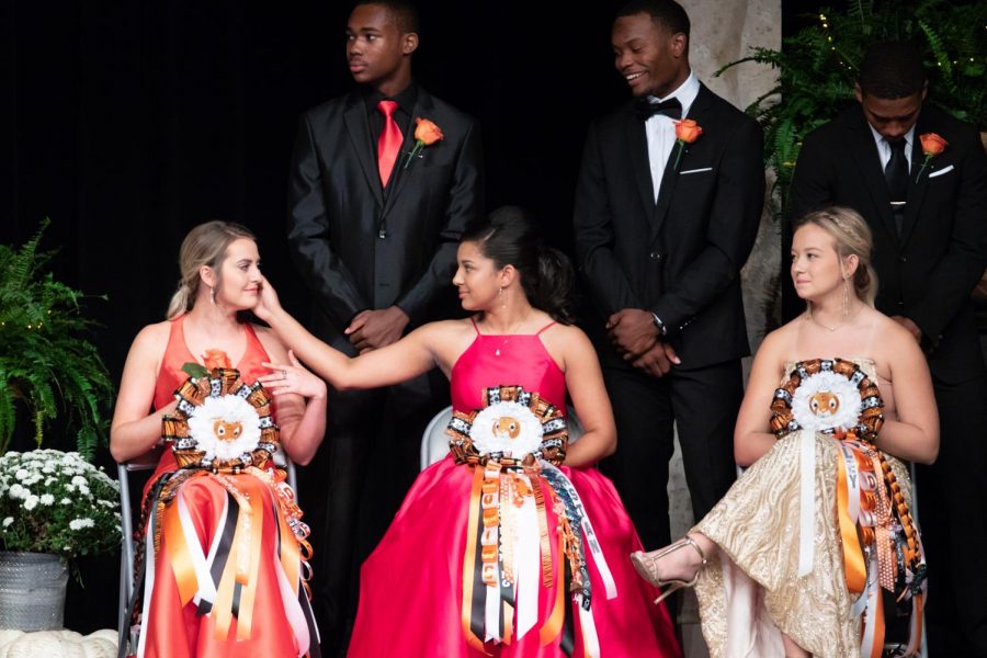 Senior Kearstan Williams wipes a tear away from fellow maid senior Allison Yancey during emotional moment shared on stage.