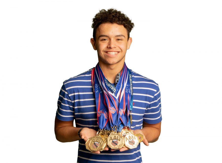 Sophomore+Logan+Diggs+shows+off+his+various+first+place+medals+from+competing+in+the+Junior+Olympics.+Diggs+participated+in+the+2018+Junior+Olympics+and+placed+in+four+events.