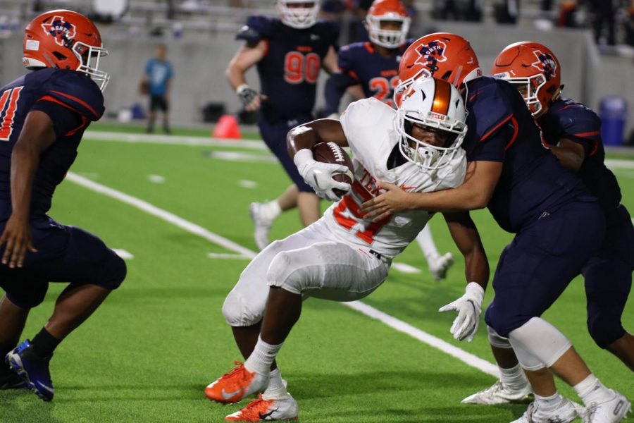 Texas Highs Chris Sutton  drives his shoulder into a McKinney defender in the third quarter of the game held in McKinney on October 5, 2018. The Tigers lost to the Bulldogs 47-44.