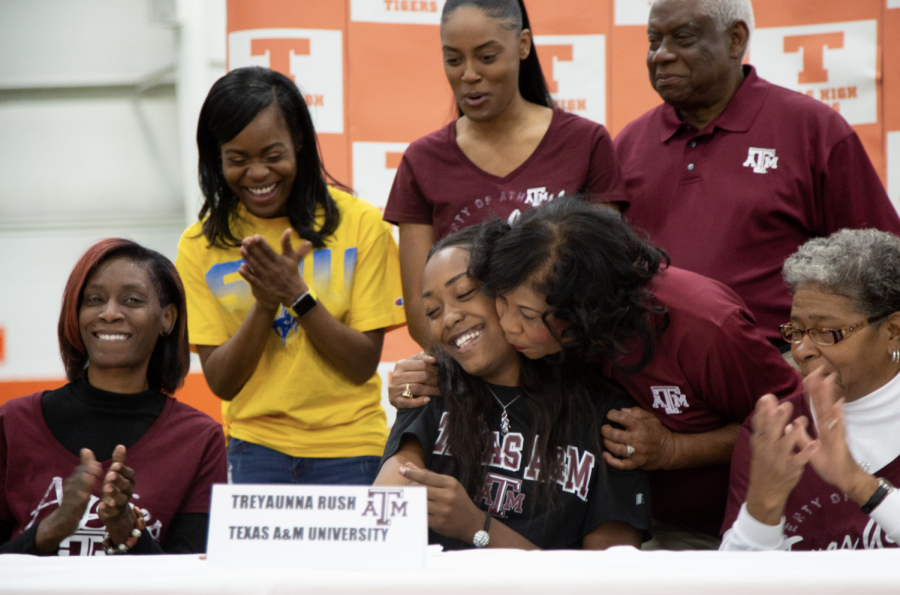 Family+members+of+senior+Treyaunne+Rush+congratulate+her+as+she+signs+her+letter+of+intent+to+Texsa+A%26M+University.+Four+seniors+signed+with+their+respective+colleges+to+further+their+athletic+careers.+