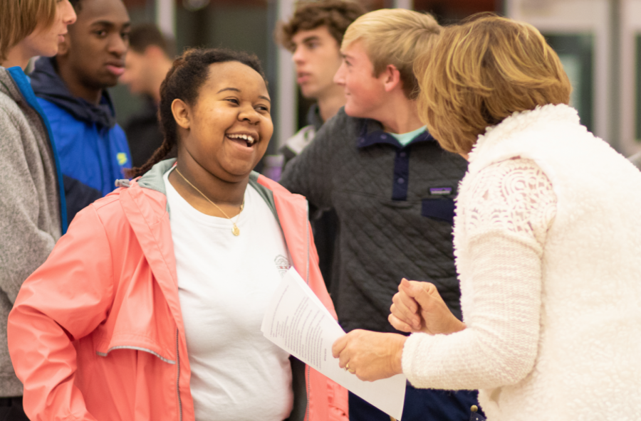 At the college fair, Senior Autumn Golden speaks with a college recruiter. The event garnered many students and college recruiters to discuss future endeavors. 