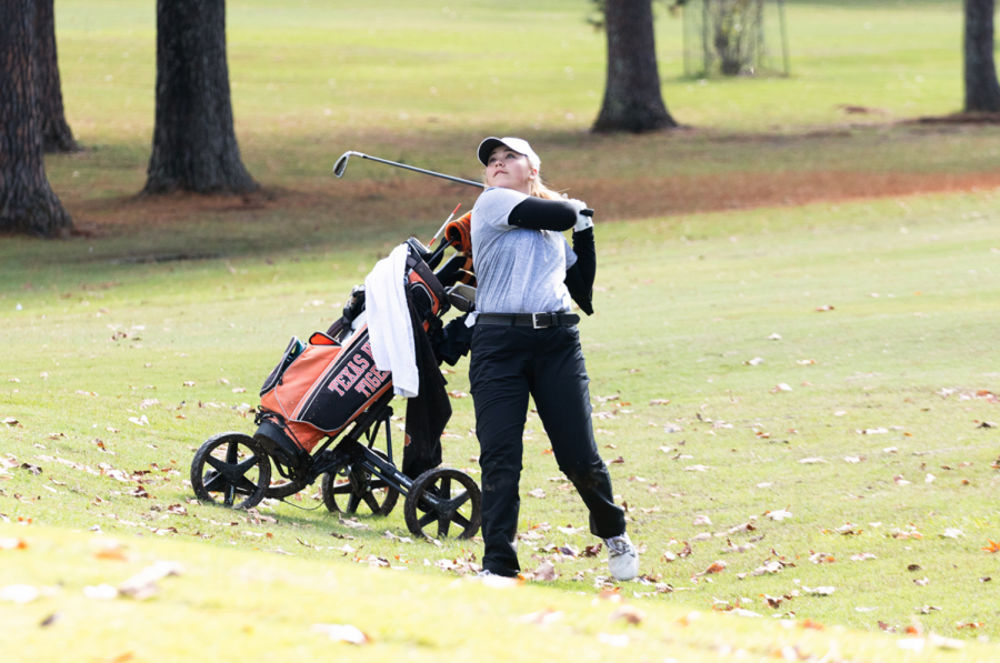 Sophomore Gracie Henard swings her golf club. Colleges noticed Henards abilities and potential.