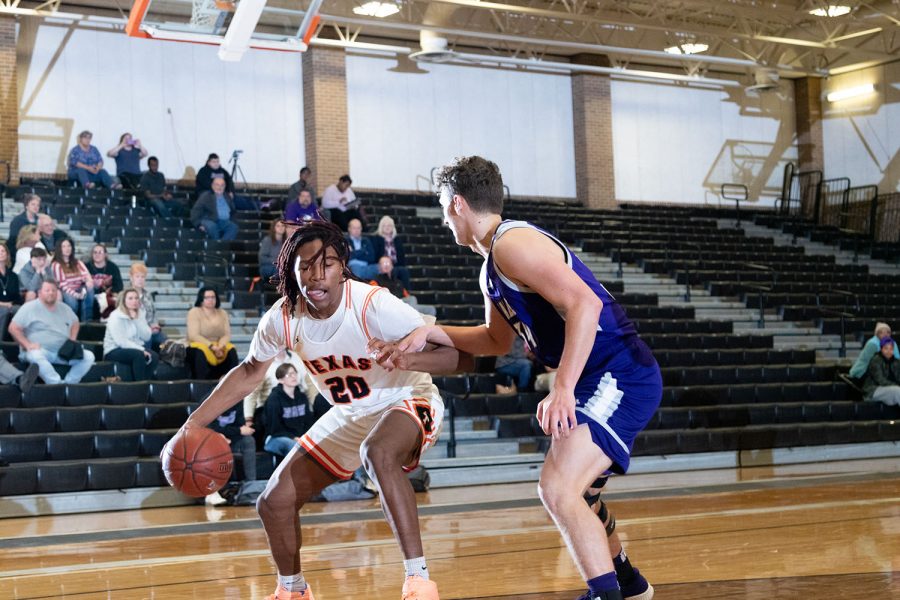 Sophomore forward Clayton Smith looks to dribble past his defender. The Tigers beat the Hallsville Bobcats at home 69-49.