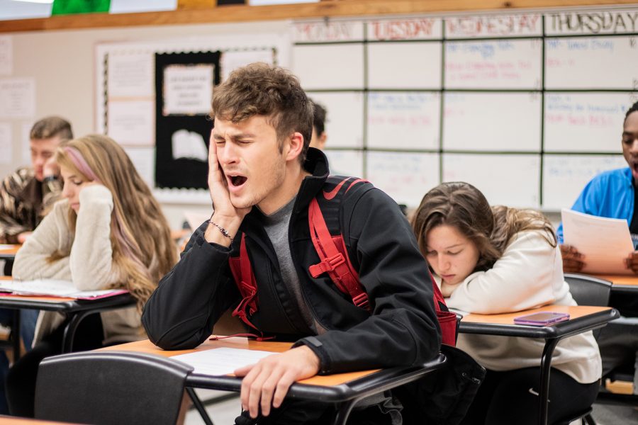 Senior Andrew Davis illustrates yawning during class. Scientists have linked yawning to multiple stimuli such as tiredness, empathy, an overheating brain and temperature.