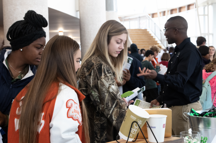 Seniors+Elaina+Roberson+and+Kylee+Spriggs+observe+brochures+during+the+career+fair+last+week.+The+fair+attracted+various+students+looking+for+local+job+opportunities+in+Texarkana.+