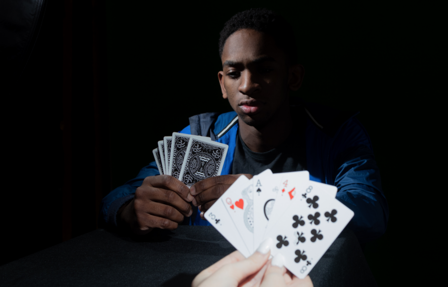 Junior Cameron Alcorn focuses on his hand of cards. He is currently playing Speed, a quick-paced and competitive card game.