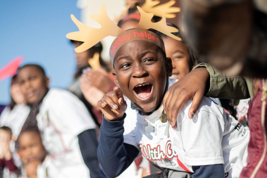 Children burst with excitement as the fleet of police cars and fire trucks drive in a parade at Shop with Cop Texas. Shop with a Cop is an annual event that strives to make Christmas better for children in need in the community.