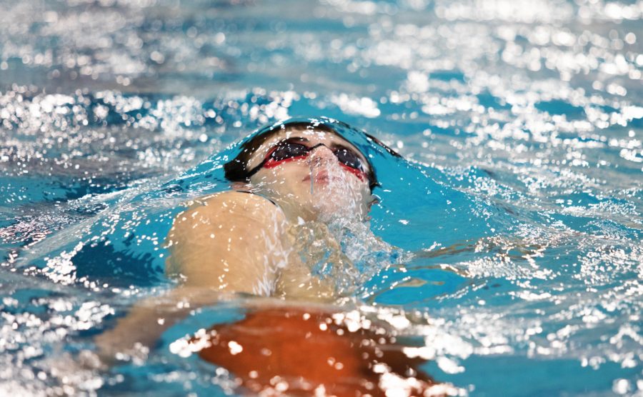 Senior+Trent+Foster+swims+in+the+100+yard+backstroke.+Foster+placed+nine+out+of+16+in+the+event.+