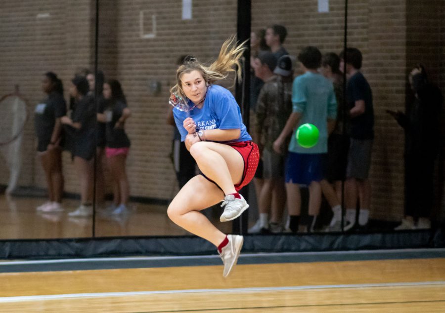 Junior Emma Lindsay jumps in the air to dodge an incoming ball at the annual Dust Bowl. This Dust Bowl was the 5th year the tournament occurred.